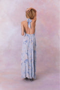 Light blue floral halter maxi dress from back view with neck tie and gathered waist