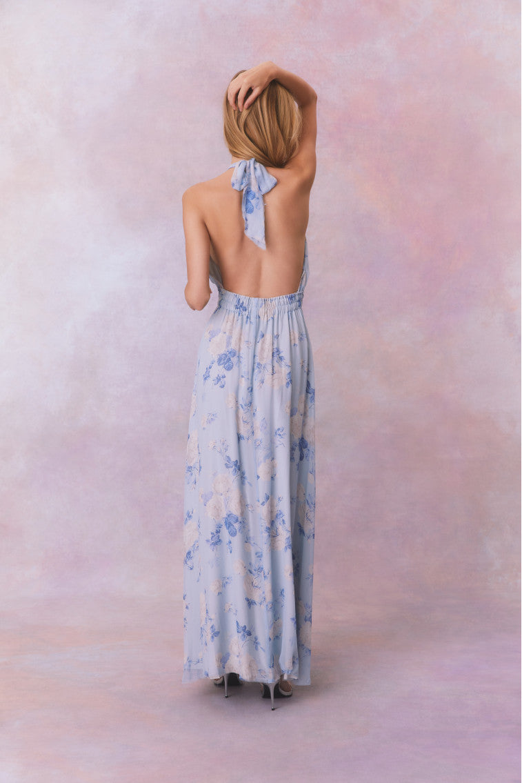 Light blue floral halter maxi dress from back view with neck tie and gathered waist