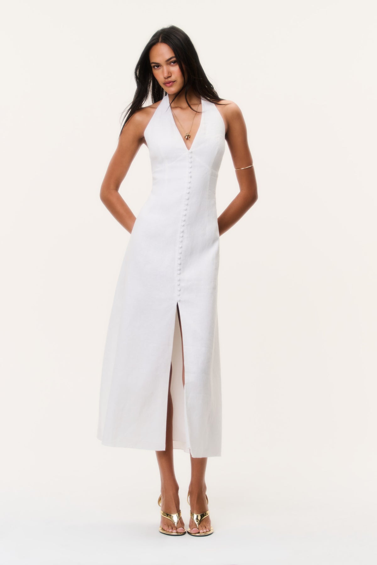 White linen halter maxi dress with V neckline, front buttons, and center slit.