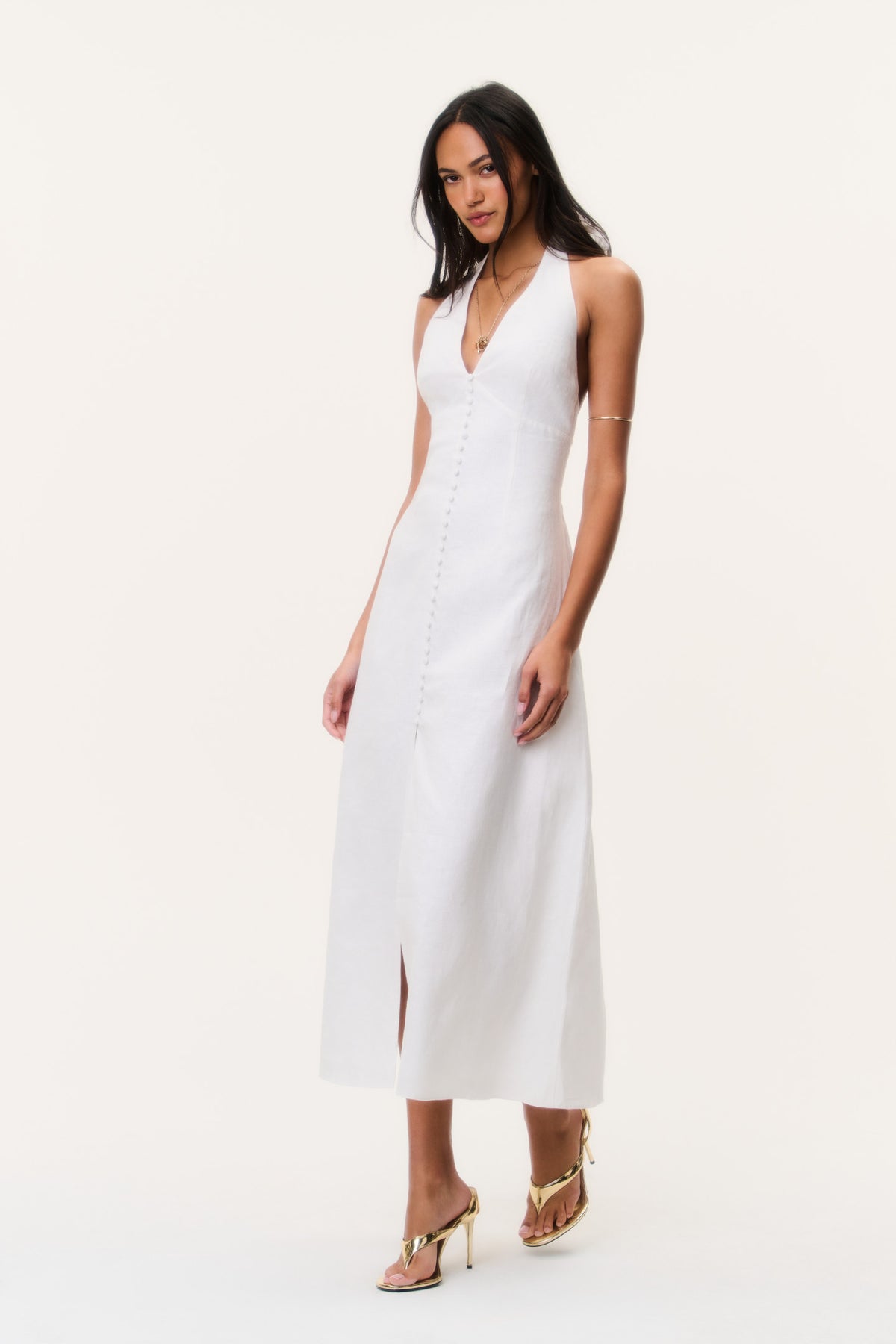 White linen halter midi dress with V neckline, front buttons, and side slit.