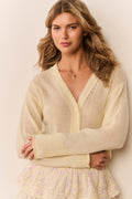 Lightweight cashmere cardigan, light cream, V-neck button-front, close-up, long sleeves