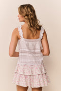Light pink floral ruffle mini skirt with layered ruffle tiers at hem