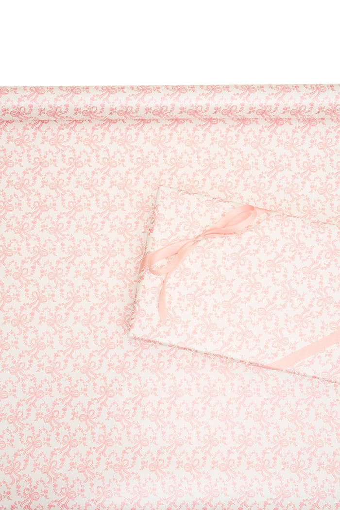 Pink gift wrapping paper with delicate bow and floral line pattern
