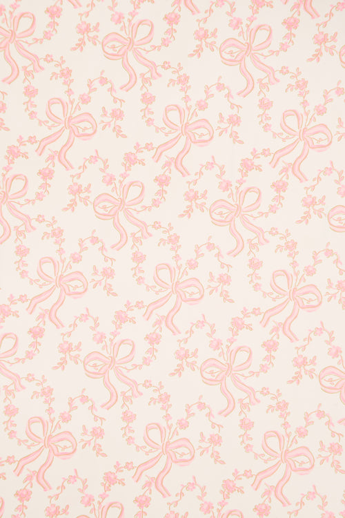Light pink gift wrap paper with repeating bow and floral line design