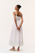 White cotton maxi dress back view with thin straps and pastel embroidered yoke