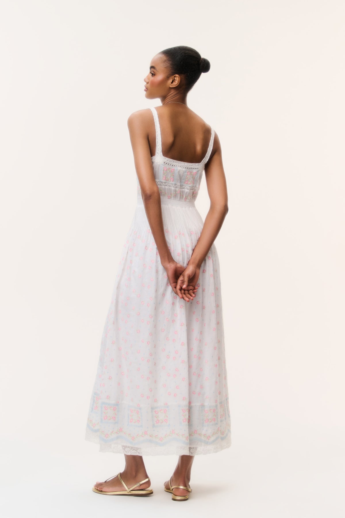 White cotton maxi dress back view with thin straps and pastel embroidered yoke