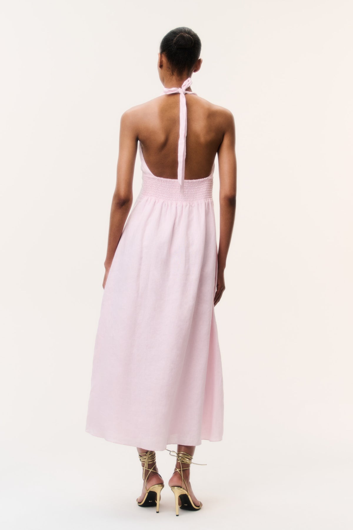 Light pink linen halter maxi dress with open back tie and center seam slit.