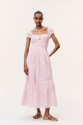 Pink floral cotton maxi dress with puff sleeves, square neckline, and tiered skirt