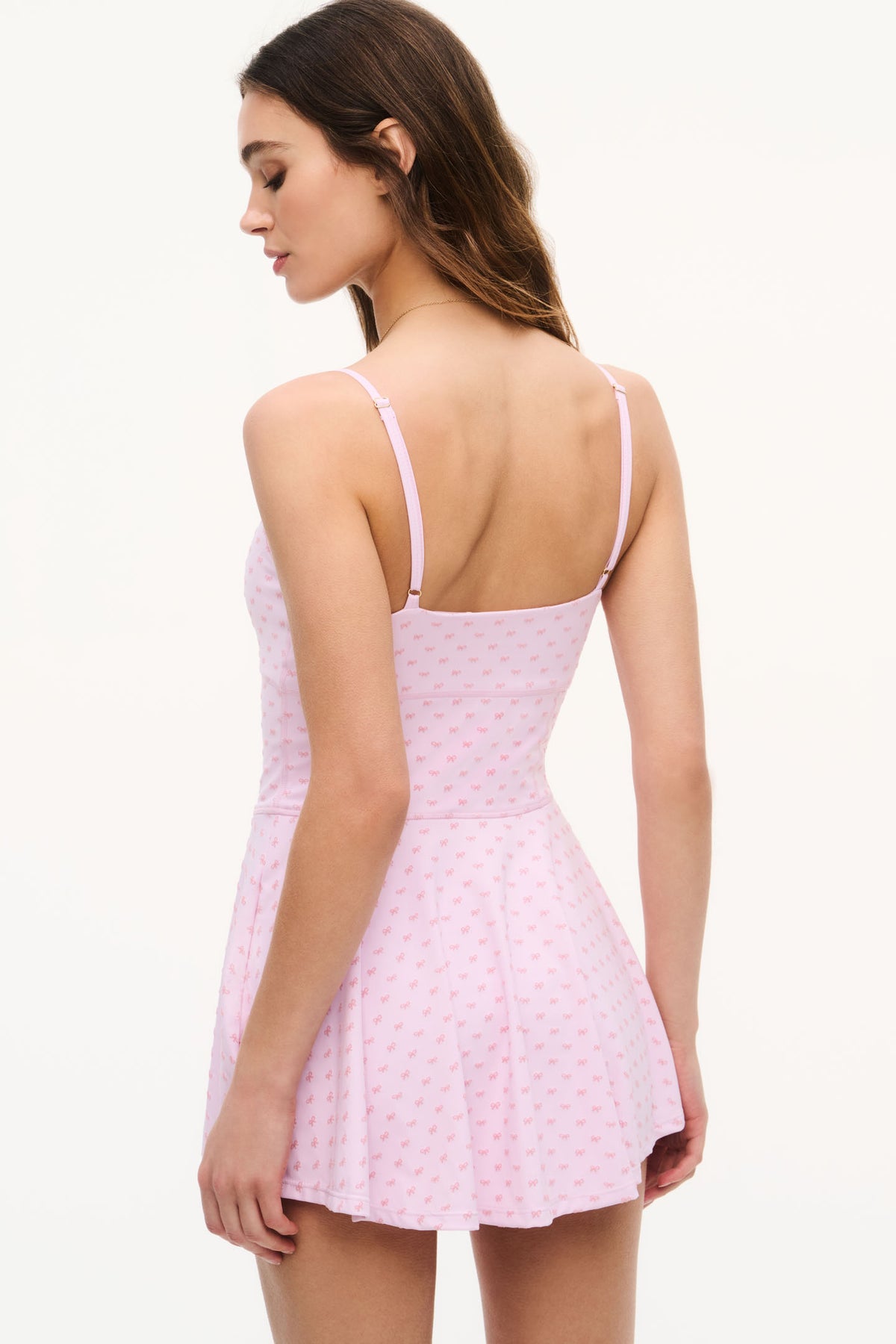 Back view of pink active dress with thin straps and ruffled hem