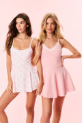 Two active dresses: pink printed and solid pink skater styles with spaghetti straps