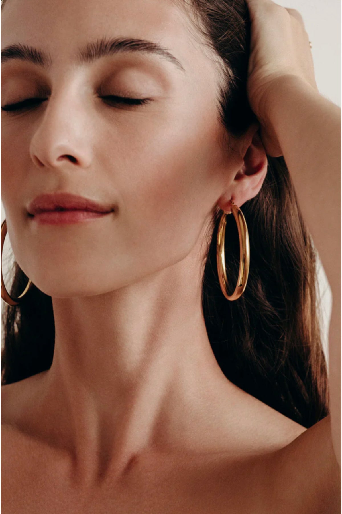BYCHARI Sade L gold hoop earrings worn, large oval hoops