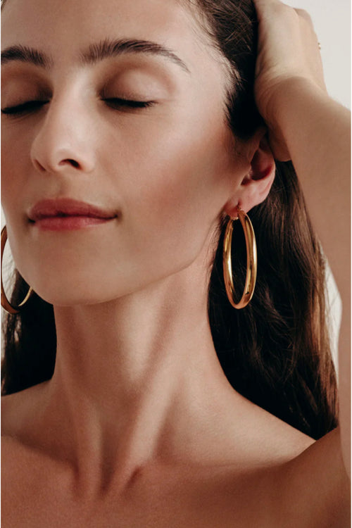 BYCHARI Sade L gold hoop earrings worn, large oval hoops