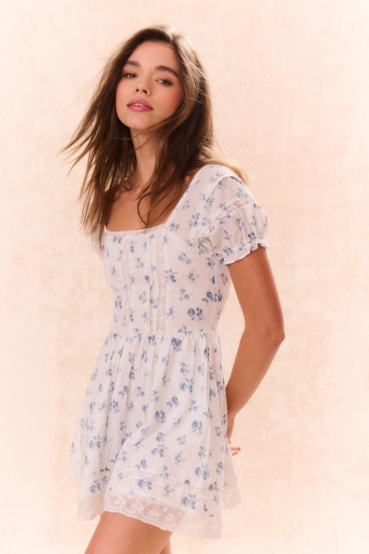 Girls light blue floral dress with square neckline, puff sleeves, and lace hem