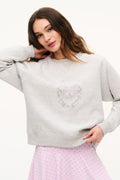 Light heather gray crewneck sweatshirt with crest graphic, long sleeves