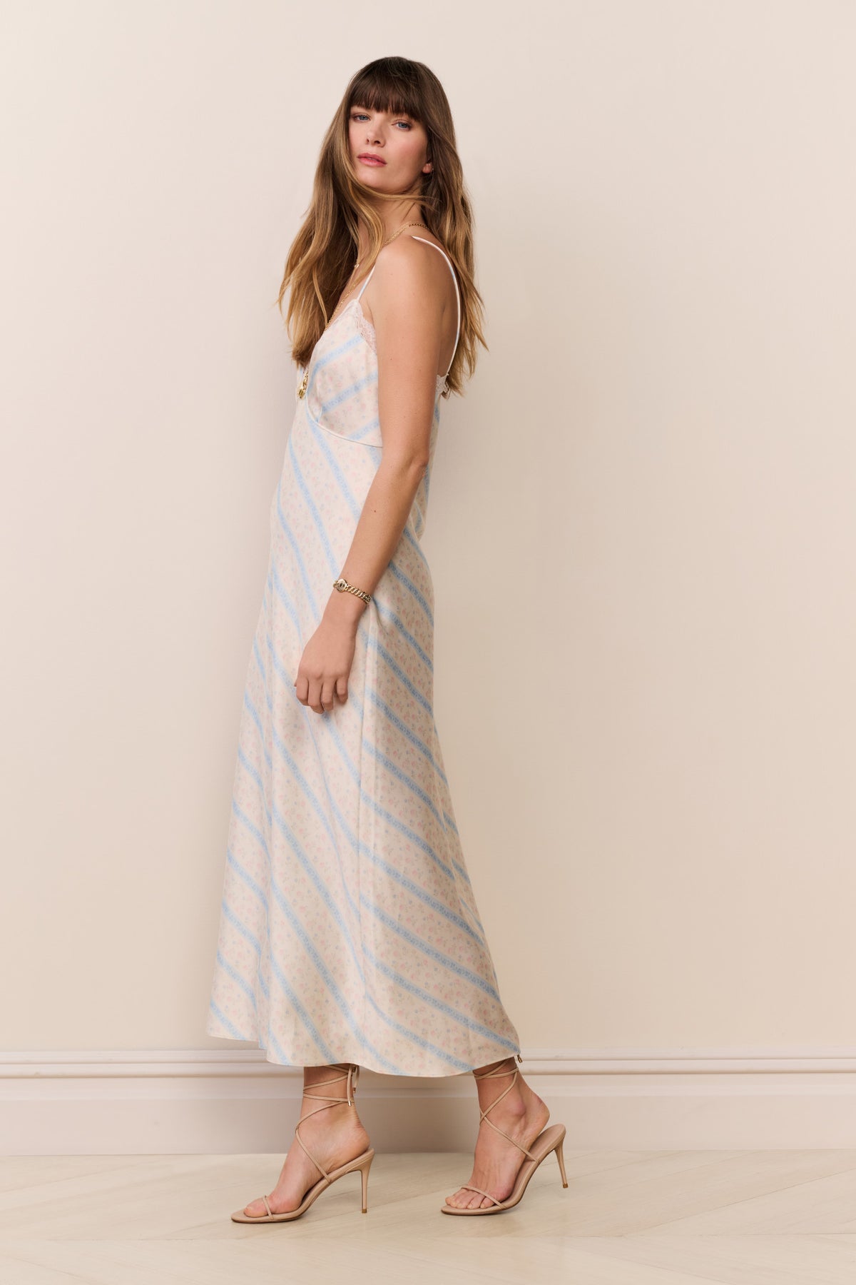Side view light blue striped maxi slip dress with lace-trim straps and V-neck
