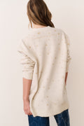 Cream jacquard wool cardigan with gold star pattern, open back view