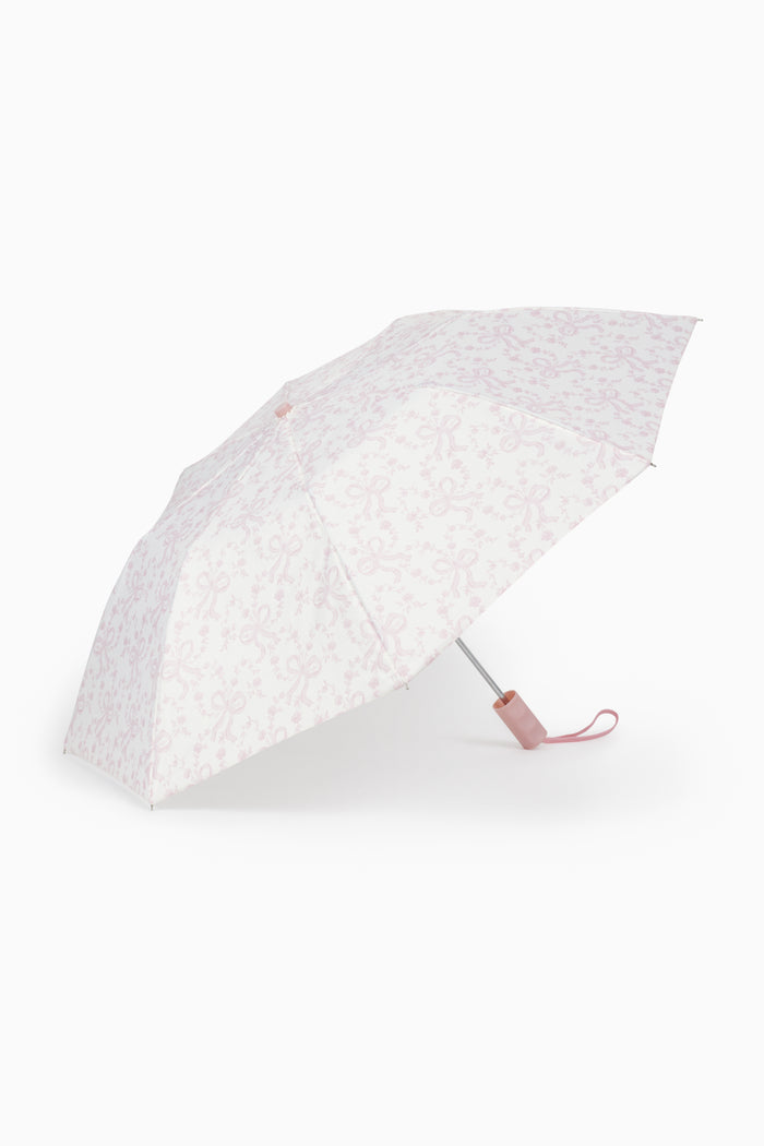 Light pink floral umbrella with curved wooden-look handle and wrist strap