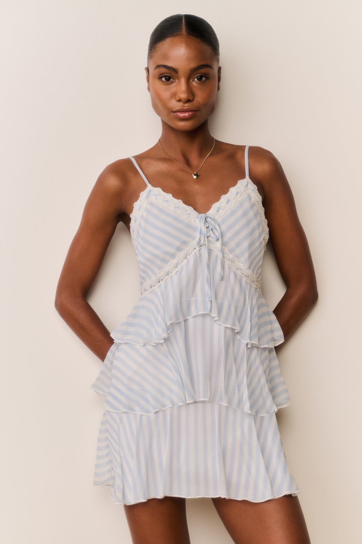 Light blue striped chiffon mini dress front view, lace-trimmed neckline and tiered skirt ruffles