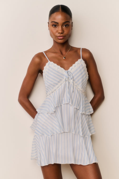 Light blue striped chiffon mini dress front view, lace-trimmed neckline and tiered skirt ruffles