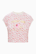 Cropped pink floral ringer tee with chest football-helmet graphic and crew neck