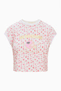 Cream floral ringer tee with white crew neck trim and centered team graphic