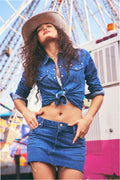 Medium-wash denim mini skirt with raw hem, button front, and front patch pockets