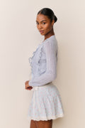 Light blue eyelet ruffle cardigan with lace trim and long sleeves
