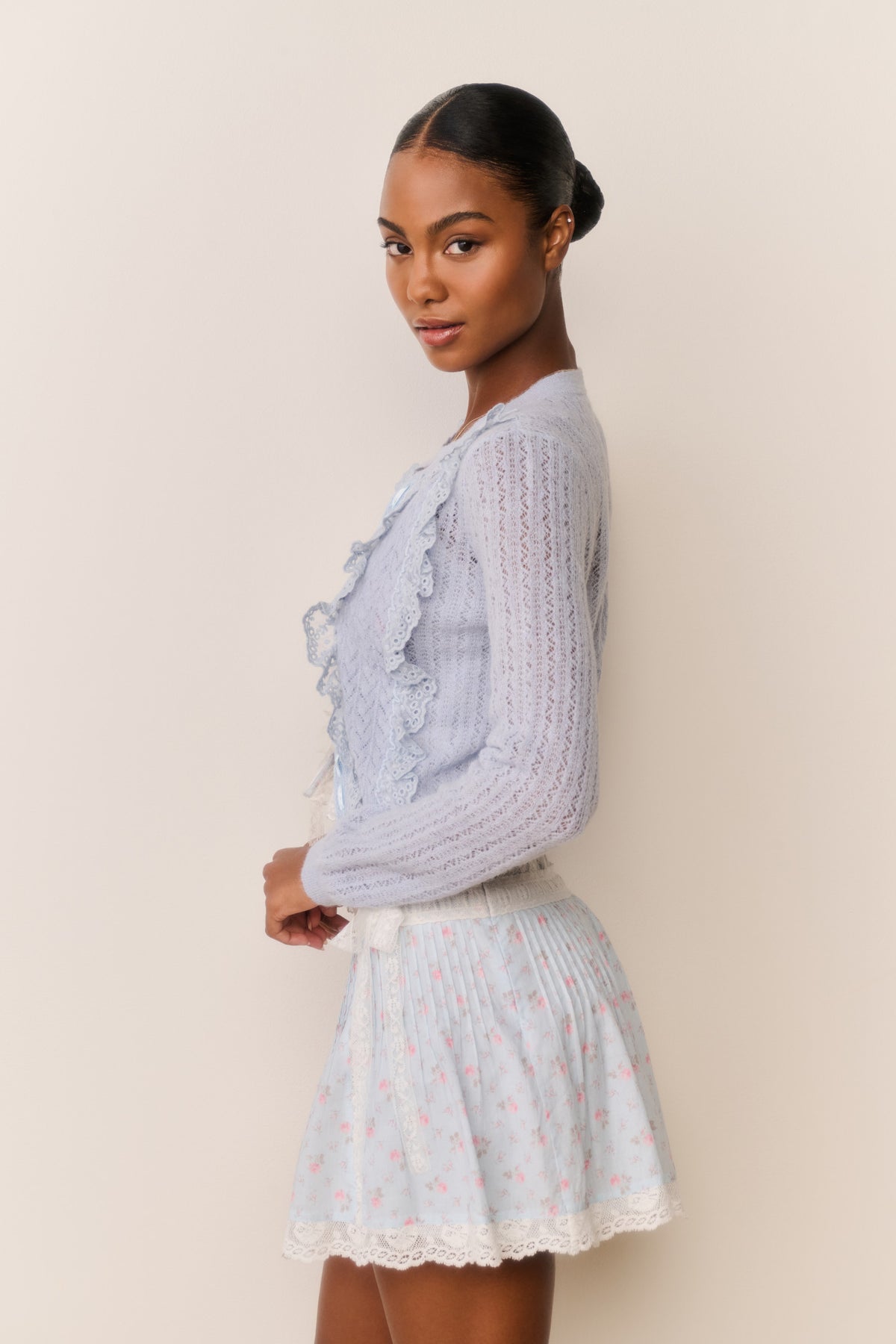 Light blue eyelet ruffle cardigan with lace trim and long sleeves