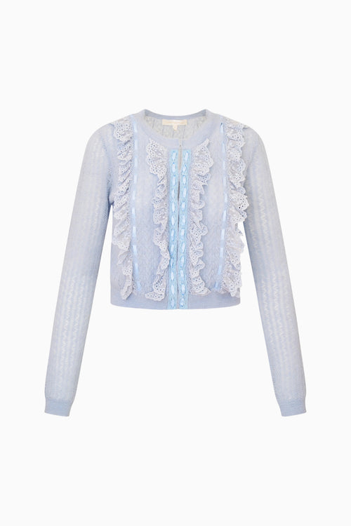 Light blue cardigan with ruffled details on a white background