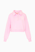Pink fleece polo sweatshirt with button placket, cropped hem, and chest logo