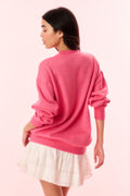 Pink pullover sweatshirt back view with dropped shoulders and ribbed cuffs