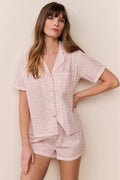 Pink patterned polo pajama short set with button-up V-collar top and matching shorts