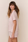 Pink patterned polo pajama set with button-front top and short shorts, side view
