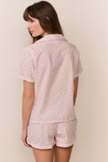 Pink patterned polo pajama set with short-sleeve top and matching shorts, back view