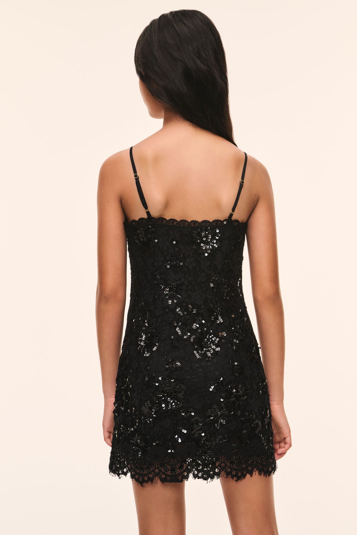 Black lace jetta dress back view with spaghetti straps and lace trim hem