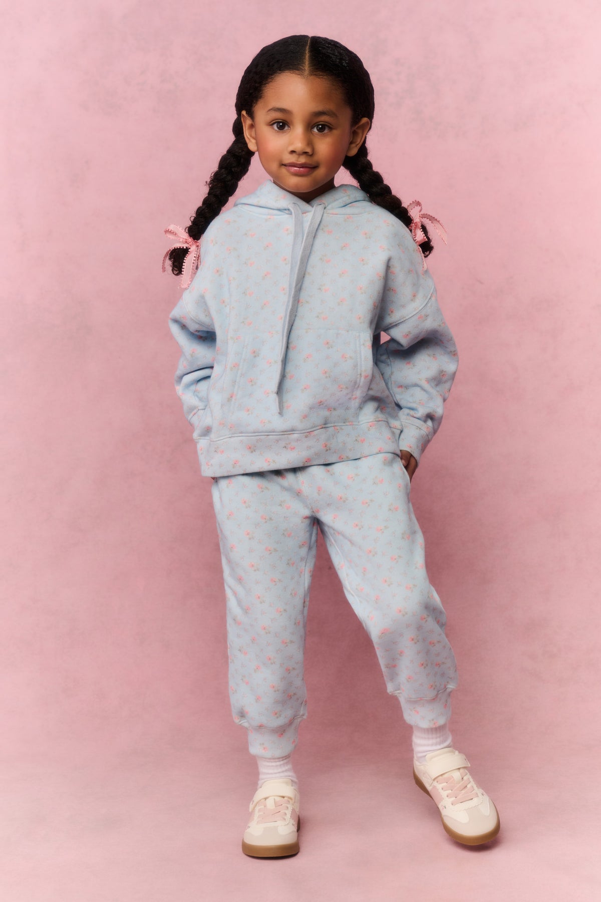 Girls' mini hoodie front view, light blue small print, pouch pocket and drawstring hood