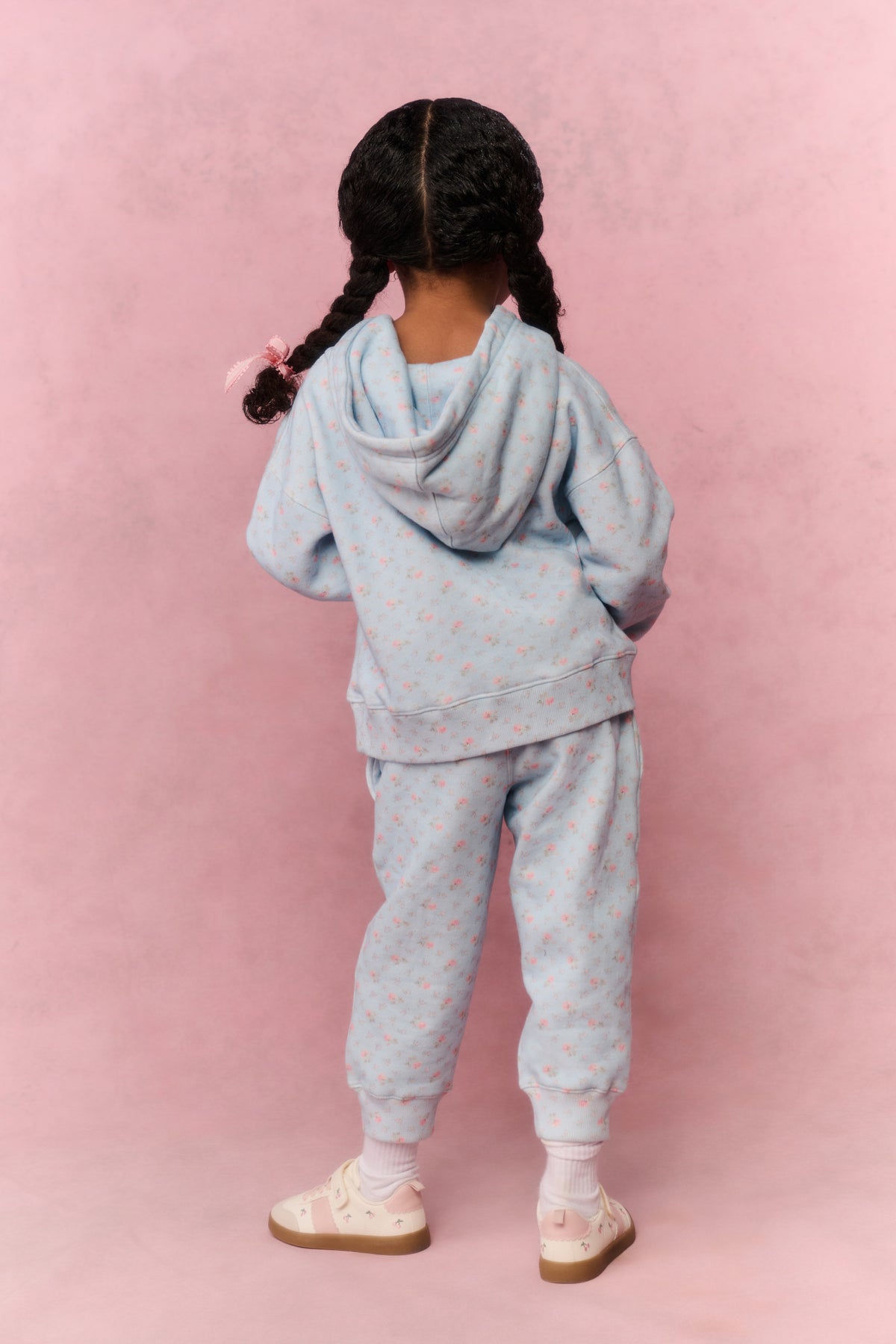 Girls' mini hoodie, back view, light blue with small print and adjustable hood drawstrings