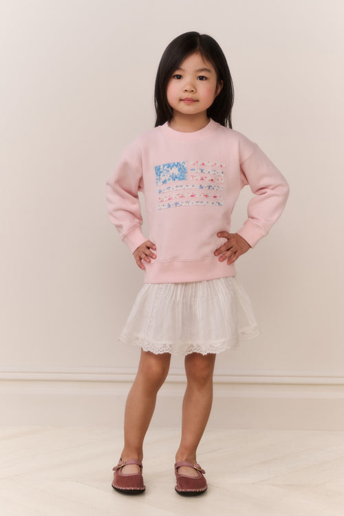 Girls' pink crewneck pullover with colorful front graphic, lace skirt and mary jane shoes
