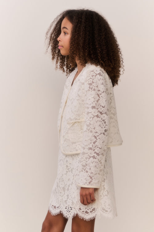 Ivory lace jacket with front button placket and long sleeves, side view