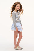 Light blue tiered ruffle skirt with elastic waist, side view