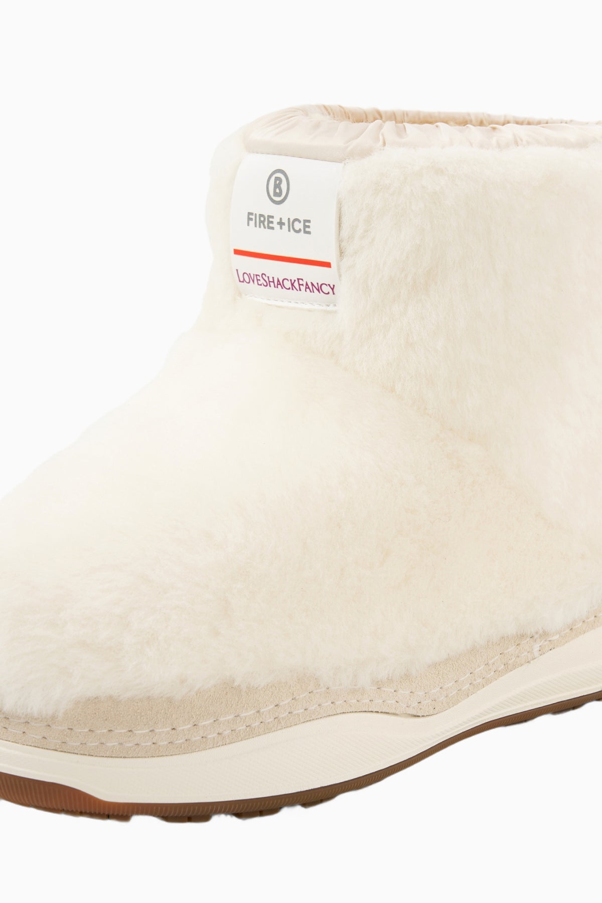 Off-white girls boot with faux-fur upper, stitched side seam, and light sole