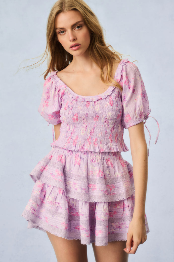 Pink printed puff-sleeve peplum top with smocked bodice and ruffled skirt tiers