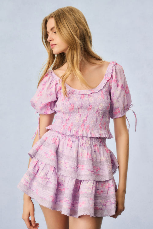 Pink printed peplum top with puff sleeves, smocked bodice, and ruffled tiers