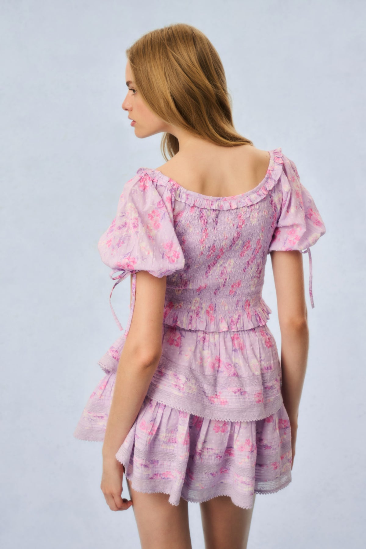 Pink printed peplum top, back view with puff sleeves and ruffled skirt tiers