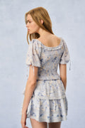 Blue floral print mini dress with tiered ruffles and drawstring sleeves, back view