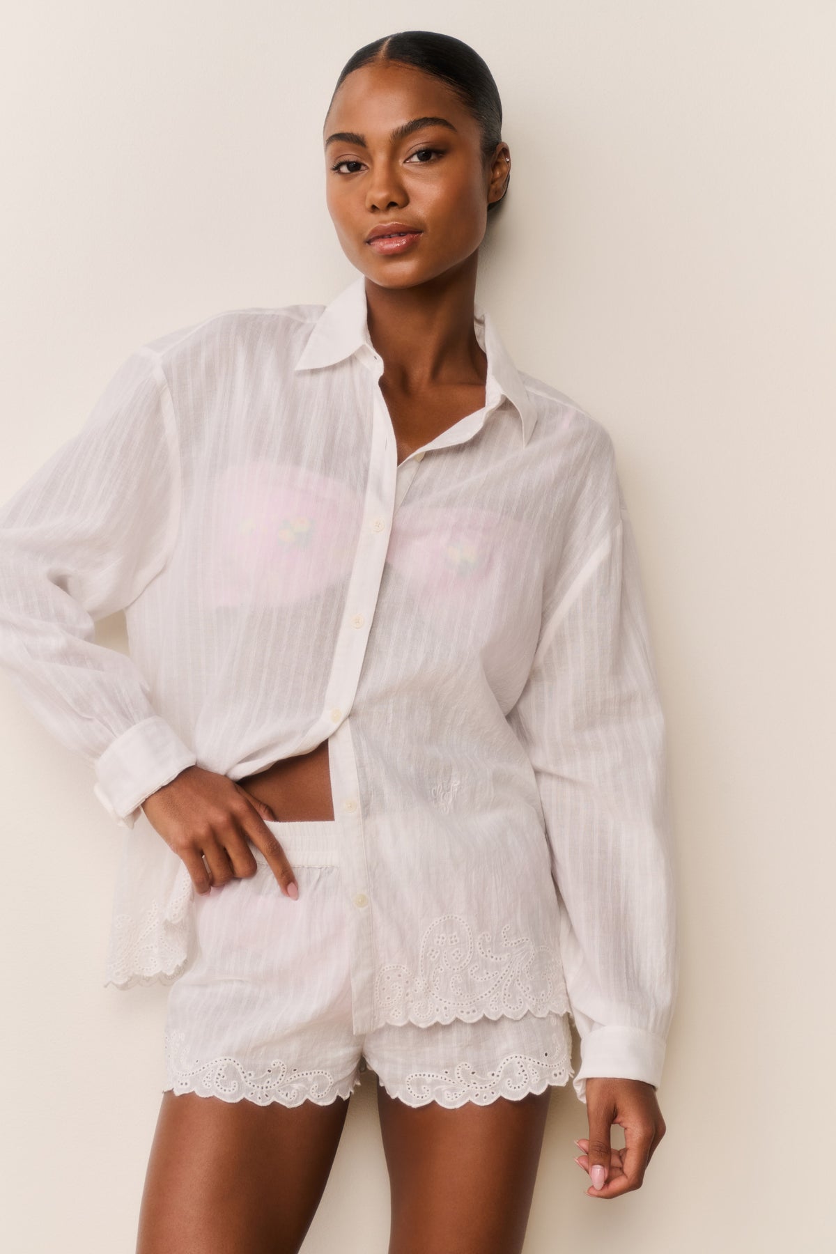 Embroidered cotton button-up shirt in white, front view with long sleeves and scalloped hem