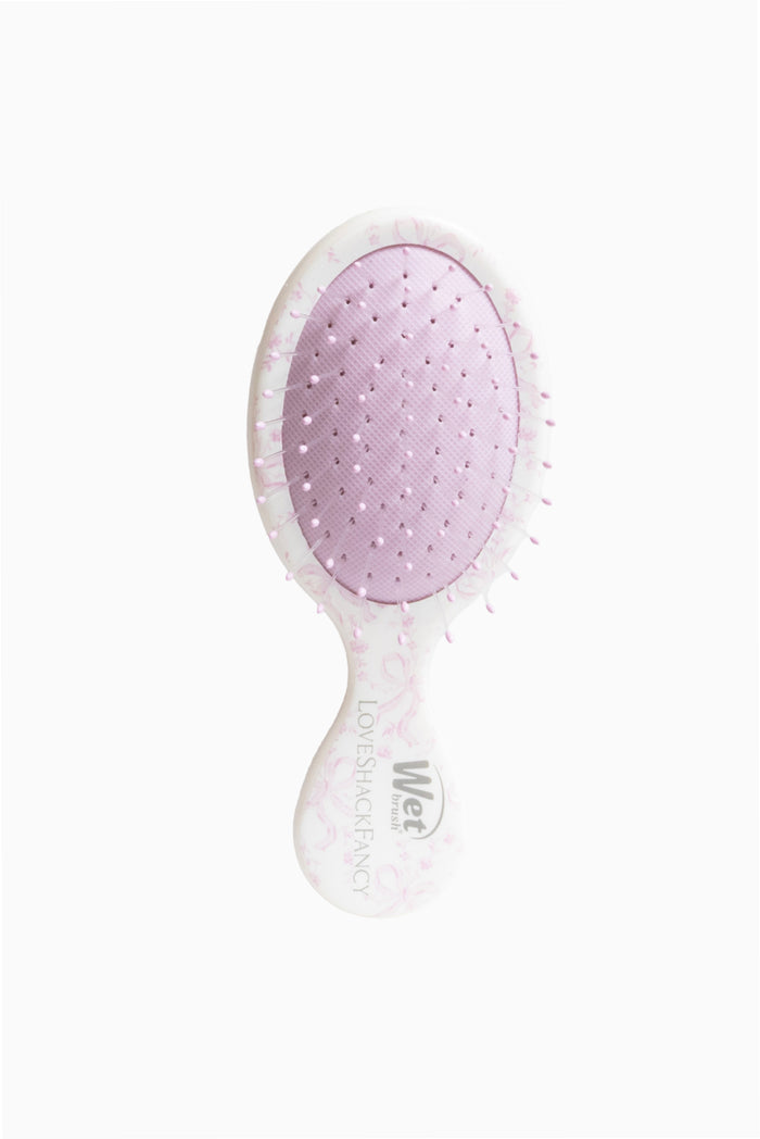 Pink and white mini detangling hair brush with dotted bristle pad