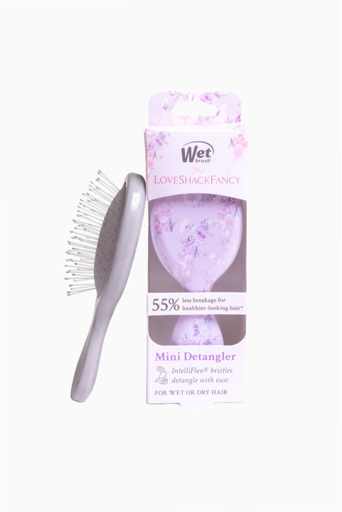 Mini detangling hair brush with gray pad and purple floral pattern