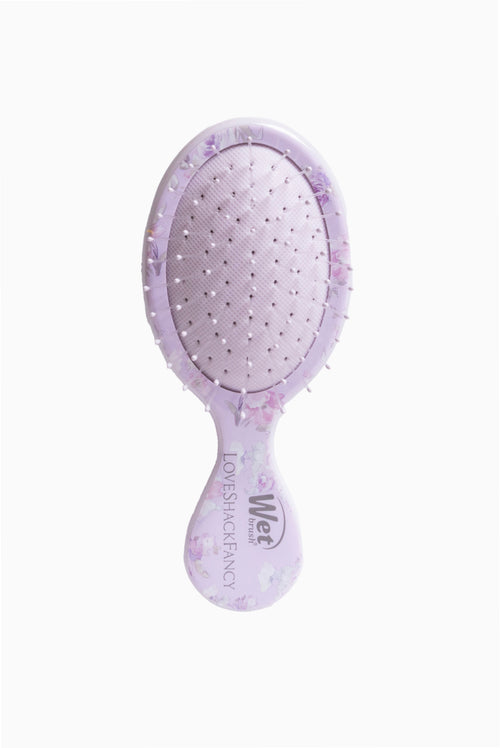 Lavender mini detangling brush with rounded paddle and pin bristles