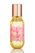 Mini hair and body mist bottle with rose-gold cap, gold ribbed glass, pink floral label